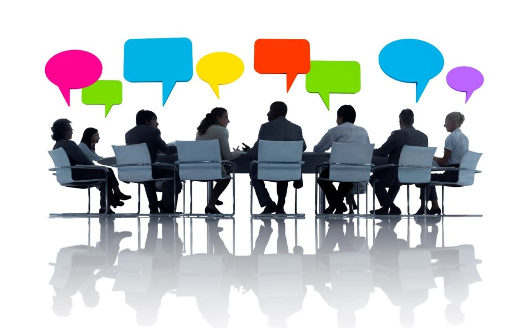 Management committee discussing around a boardroom table